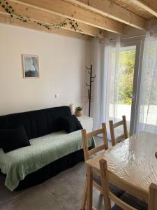 - un salon avec un canapé et une table dans l'établissement Petit Fare Rochois avec mezzanine, à La Roche-des-Arnauds