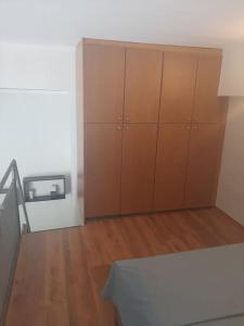 a room with wooden cabinets and a wooden floor at City Loft in Sparta