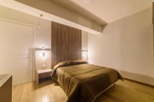 A bed or beds in a room at Grand Hotel Europa Rivisondoli Centro