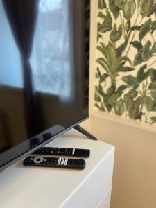 two remote controls sitting on top of a tv at DMR Apartments in Košice