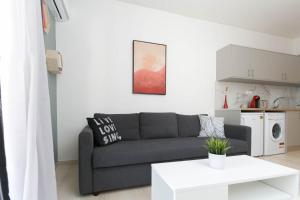 a living room with a couch and a table at In the heart of the city in Heraklio