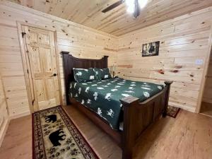a bedroom with a bed in a log cabin at The Hitching Post: Spacious 5BR/4BA Rancher in Pigeon Forge