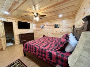 a bedroom with a bed and a ceiling fan at The Hitching Post: Spacious 5BR/4BA Rancher in Pigeon Forge