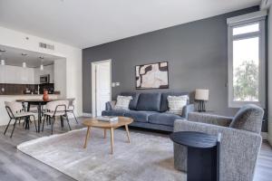 a living room with a blue couch and a table at Mountain View 2br w gym roof wd nr highways SFO-1313 in Los Altos