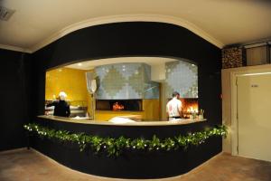 two people in a kitchen with a fireplace at Il Casale Della Stella in Baronissi