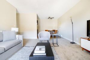 a living room with a couch and a table at Foster City 2BR w Gym Pool WD nr highways SFO-567 in Foster City
