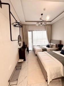 a bedroom with two beds and a mirror at Oasis in the Desert in Al Qurayyah