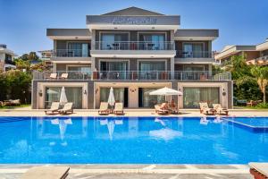 a large swimming pool in front of a building at Vadi Boutique Hotel in Cesme