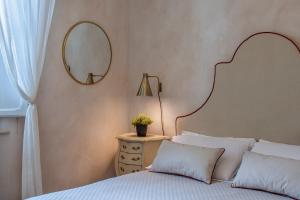 um quarto com uma cama com um espelho na parede em Villa Liberty Urbino em Urbino