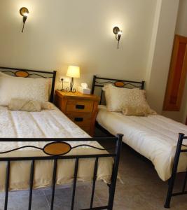 a bedroom with two beds and a night stand with lamps at Villa Lobos in Lliber +40 photos