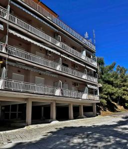 a large building with balconies on the side of it at Sea Esta Apartment in Nea Peramos