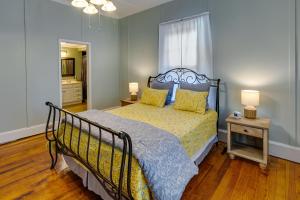 una camera da letto con letto con struttura nera di Quaint Anderson Home with Sunroom, Walk To Downtown! ad Anderson