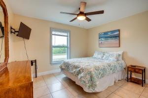 a bedroom with a bed and a ceiling fan at Lehigh Acres Vacation Rental with Screened Patio! in Lehigh Acres