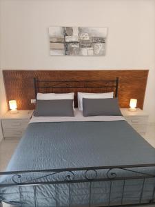 a bedroom with a large bed with two lamps at B&b da Elda Assisi in Bastia Umbra