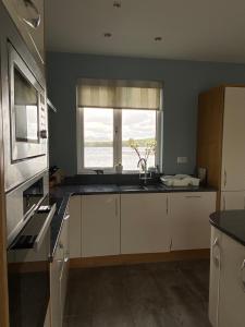a kitchen with a sink and a window at Seapoint House in Westport