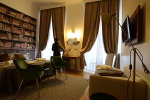 a bedroom with a bed and a couch and a desk at Spagna Ave in Rome