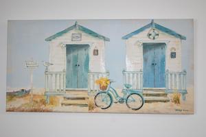 a painting of two beach huts with a bike at Apartment No. 8, 1 bed, sleeps 4 in Exmouth