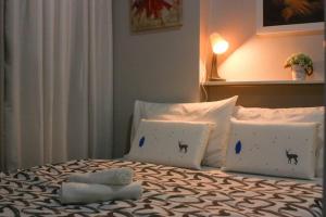 a bed with two pillows on it with at Serenity Suites: Your tranquil gateway! in Biñan