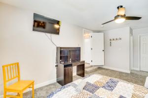 a bedroom with a bed and a tv on the wall at Central Henderson Retreat Near Dining and Lake Mead! in Las Vegas