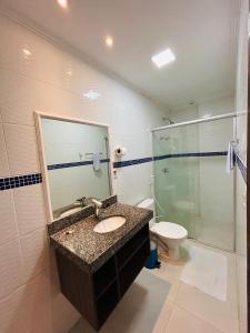 a bathroom with a sink and a shower and a toilet at Hotel Antiga Roma in Belém