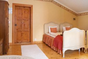 a bedroom with a bed and a wooden door at Landhaus Kekkola in Mikkeli