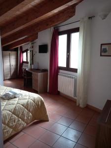 Postel nebo postele na pokoji v ubytování Agriturismo L'Ulivo