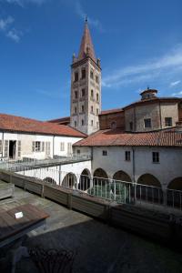 a building with a clock tower in a city at Hotel San Giovanni Resort in Saluzzo