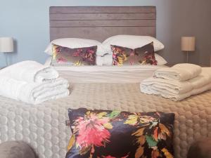 a bedroom with a bed with towels on it at 360 Town Stay Apartments & Studios in Dungarvan