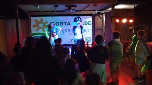 a crowd of people watching a presentation on a screen at Camping Village Costa Verde in Porto Potenza Picena