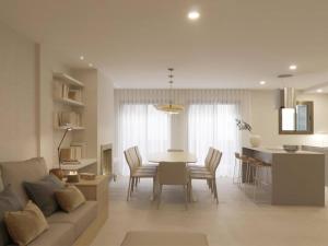 a living room with a couch and a table at Sitges Spaces Bonaire Beach, Near Everything in Sitges +23 photos