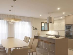 a kitchen and dining room with a table and chairs at Sitges Spaces Bonaire Beach, Near Everything in Sitges