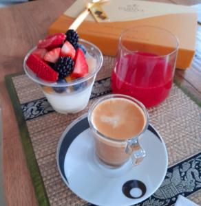 a cup of coffee and a bowl of fruit on a table at VILLA AMA in Pordenone