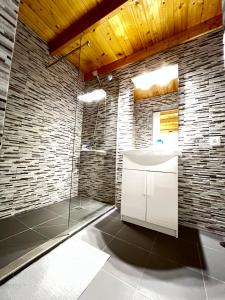 a bathroom with a white sink and a shower at Casa rosa in San Miguel de Abona +12 photos