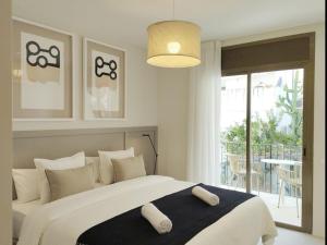 a bedroom with a large bed and a balcony at Sitges Spaces Bonaire Beach, Near Everything in Sitges