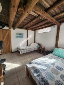 1 Schlafzimmer mit 2 Betten und Holzdecke in der Unterkunft Cabana Ferrer 