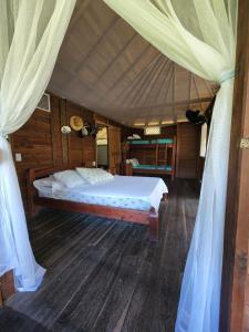 a bedroom with a large bed in a tent at Cabana Ferrer in Notecebes