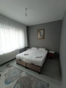 a bedroom with a bed and a window and a rug at Sweet Home in Historical Area 3B in Istanbul
