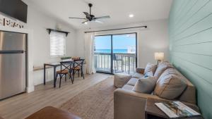 Beachside Condo 21 في شاطئ سانتا روزا: غرفة معيشة بها أريكة وطاولة