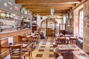 a restaurant with tables and chairs and a bar at Logis Auberge le centre poitou in Coulombiers