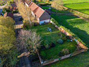 an aerial view of a farm with a barn and a field at Couples retreat Boutique style Barn conversion in Great Yarmouth