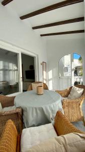 a white room with a table and chairs and a window at Casita Pepe in Jávea +17 photos