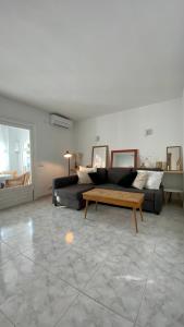 a living room with a couch and a coffee table at Casita Pepe in Jávea