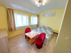 a small room with a table and two chairs at Neringa Guest House in Palanga