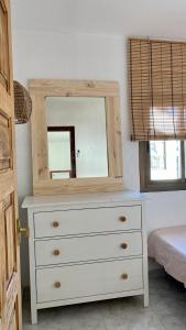 a dresser with a mirror on top of it at Casita Pepe in Jávea