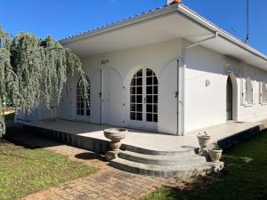 a white building with stairs in front of it at villa Moana andernos in Andernos-les-Bains +4 photos