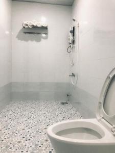 bagno con servizi igienici e telefono appeso al muro di Khách Sạn Mỹ Hằng a Soc Trang