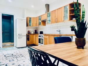 uma cozinha com uma mesa de madeira e um frigorífico branco em Luxury Flat in Le Marais - Central Paris em Paris