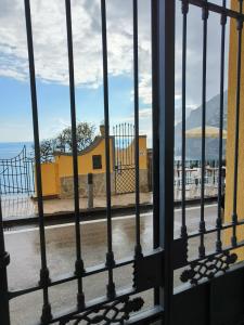 a view from a gate of a street through the fence at Casa La Bionda in Positano