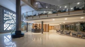 a lobby with chairs and tables in a building at Pillo Hotel & Leisure Club in Ashbourne