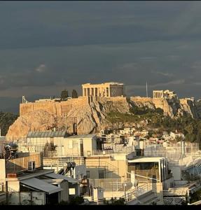widok na miasto z budynkiem na wzgórzu w obiekcie kolonaki Penthouse panoramic Acropolis view w Atenach